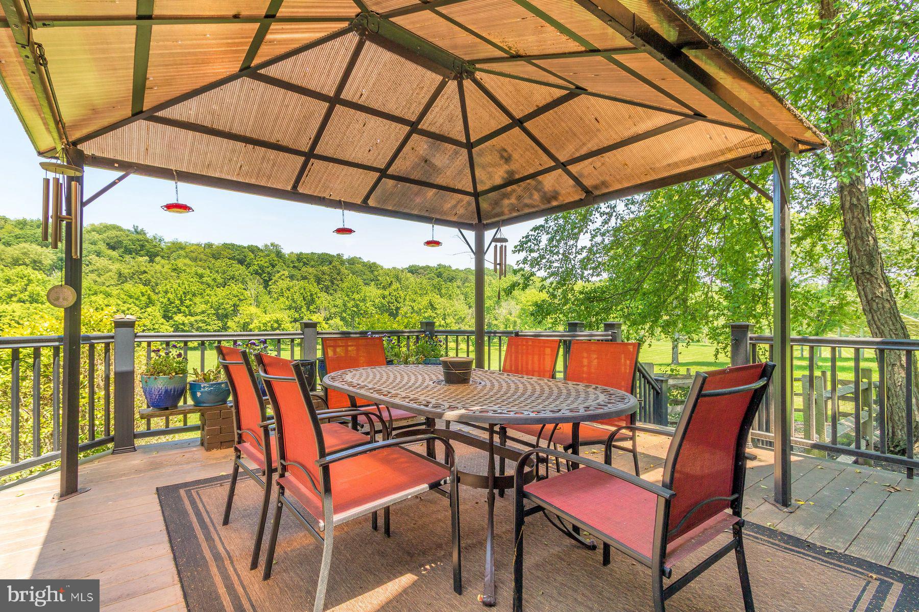 3150 Rushland Road Jamison, PA 18929 - Photo 25 of 50 a patio with wooden floor a yard a table and chairs