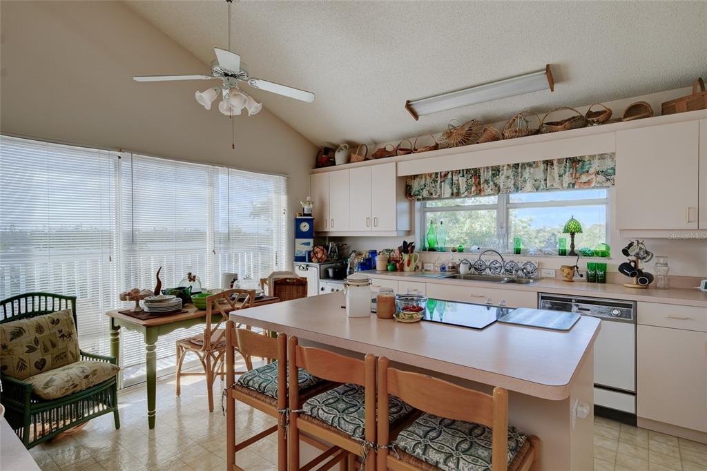 145 Burns Road Terra Ceia, FL 34250 - Photo 54 of 65 a kitchen with a table chairs stove and cabinets