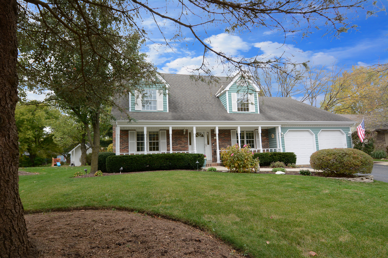 230 Perth Road Cary, IL 60013 - Photo 1 of 52 a front view of a house with a yard and trees