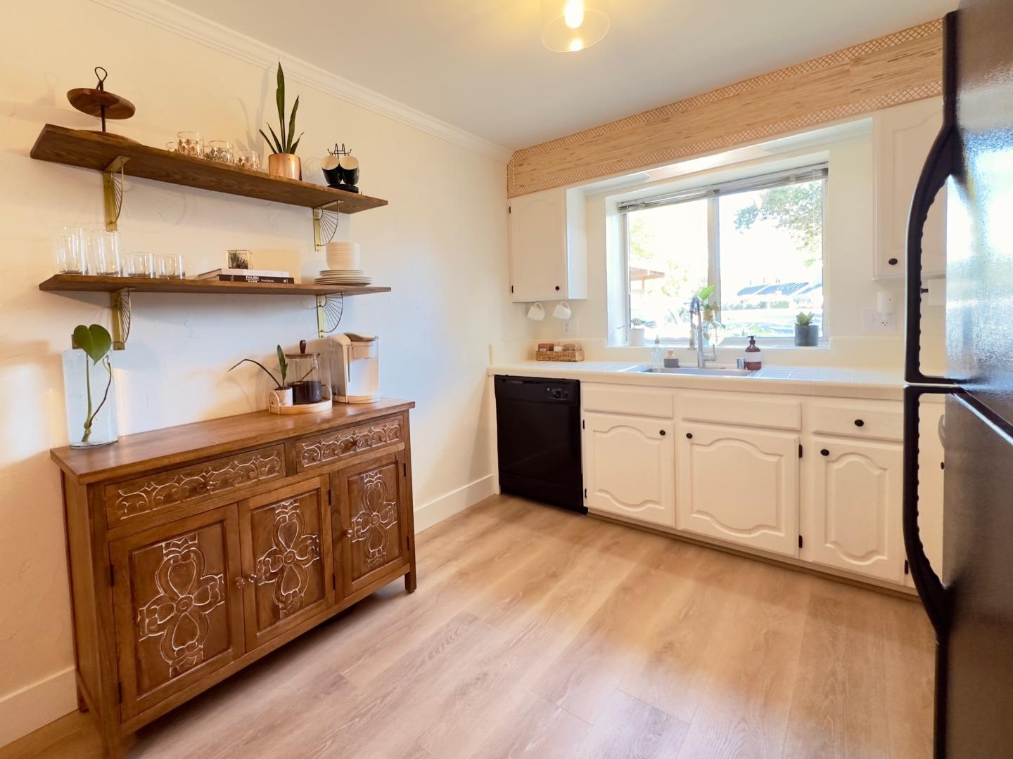 113 Madeline Drive, Unit 3 Aptos, CA 95003 - Photo 3 of 19 a kitchen with stainless steel appliances granite countertop a sink a stove and wooden cabinets