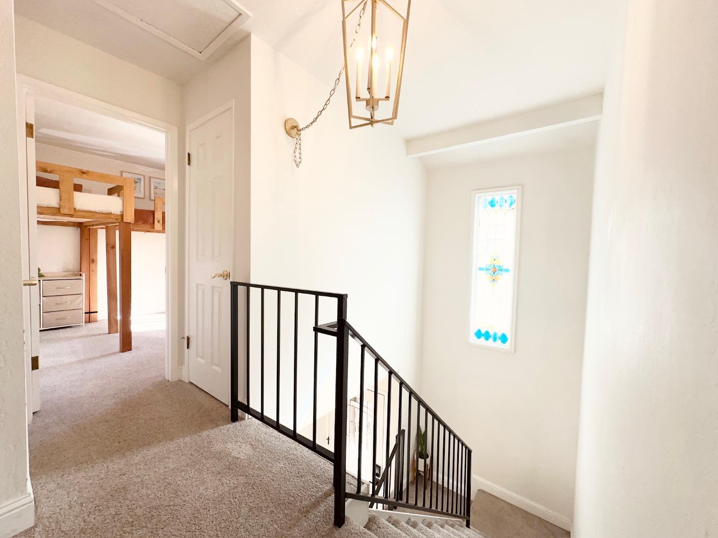 113 Madeline Drive, Unit 3 Aptos, CA 95003 - Photo 9 of 19 a view of a hallway with wooden floor and staircase
