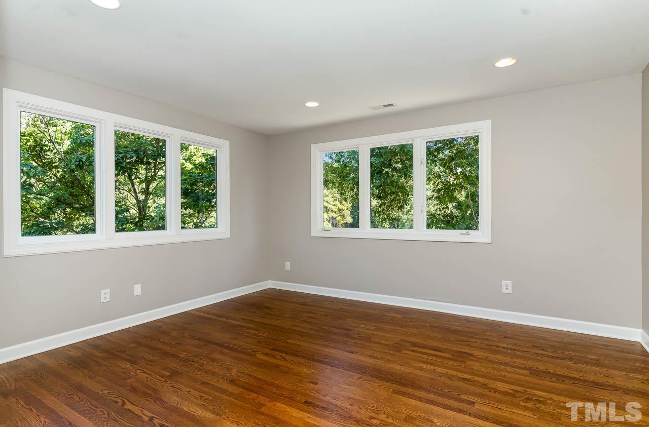4429 Mitchell Mill Road Wake Forest, NC 27587 - Photo 19 of 35 a view of an empty room with wooden floor and a window