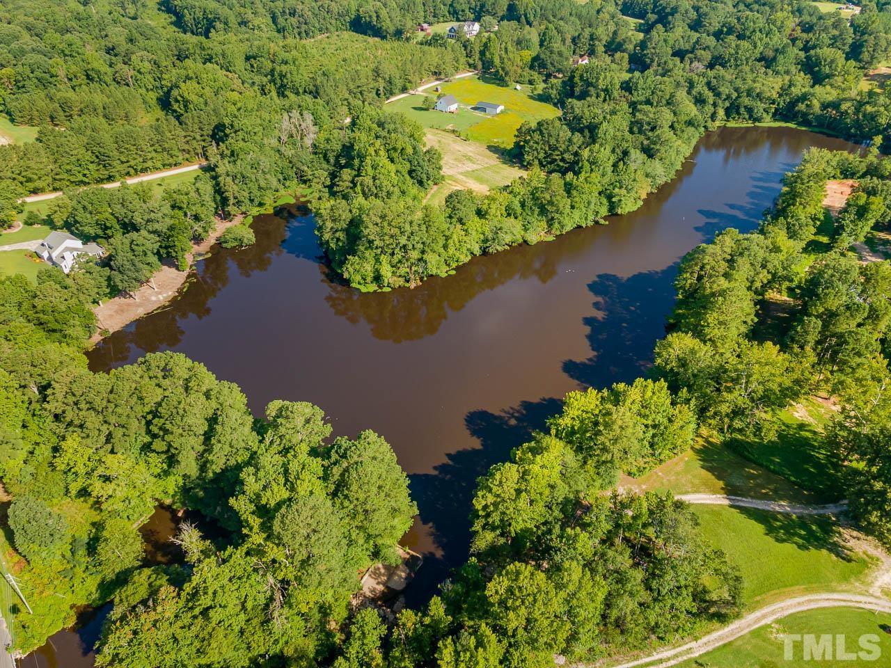 4429 Mitchell Mill Road Wake Forest, NC 27587 - Photo 29 of 35 an aerial view of a house with a yard and lake view