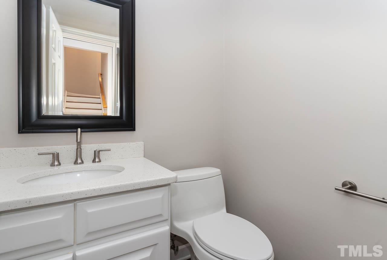 4429 Mitchell Mill Road Wake Forest, NC 27587 - Photo 6 of 35 a bathroom with a toilet sink vanity and mirror