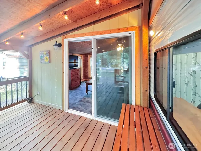 a room with furniture pool table flat screen tv and windows