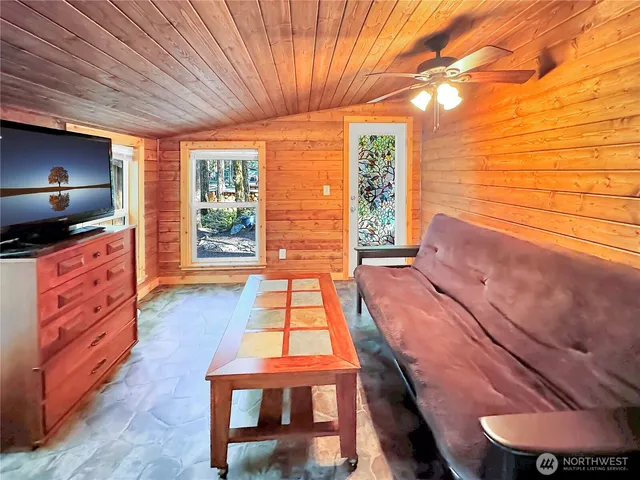 a living room with hard wood floors and a window