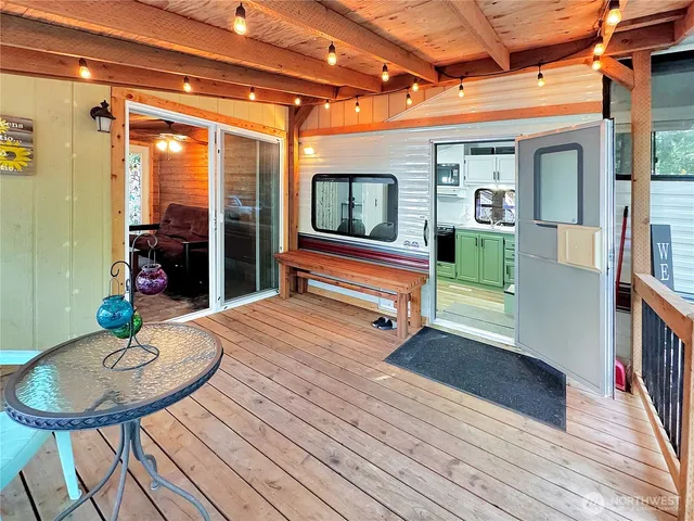 a backyard of a house with table and chairs