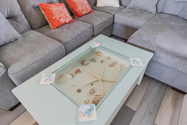 a living room with furniture and painting on the wall