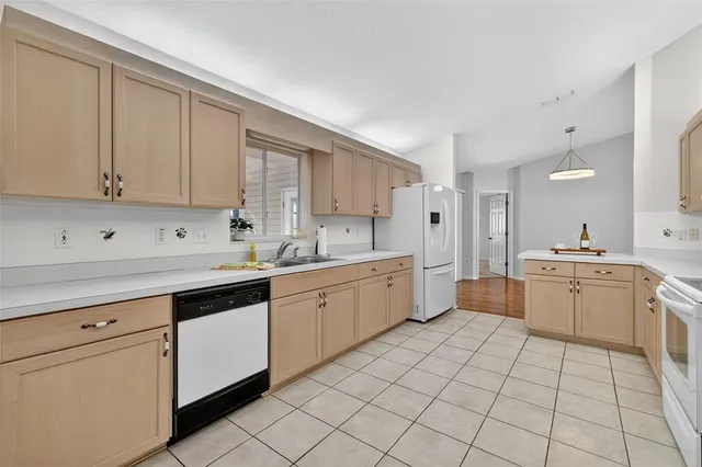 a kitchen with a sink window and cabinets