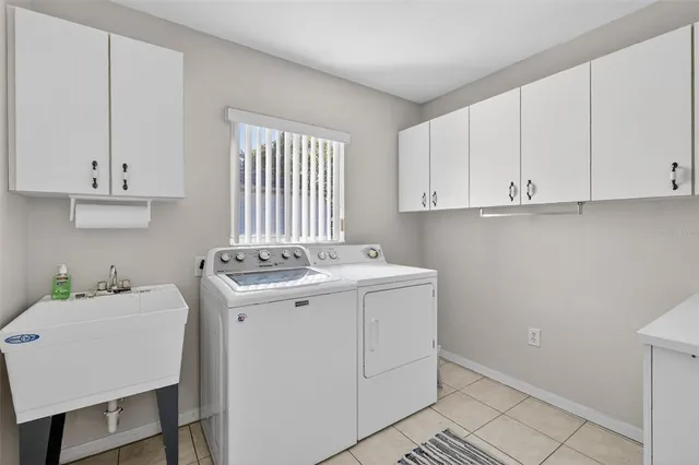 a view of a kitchen with sink and cabinets