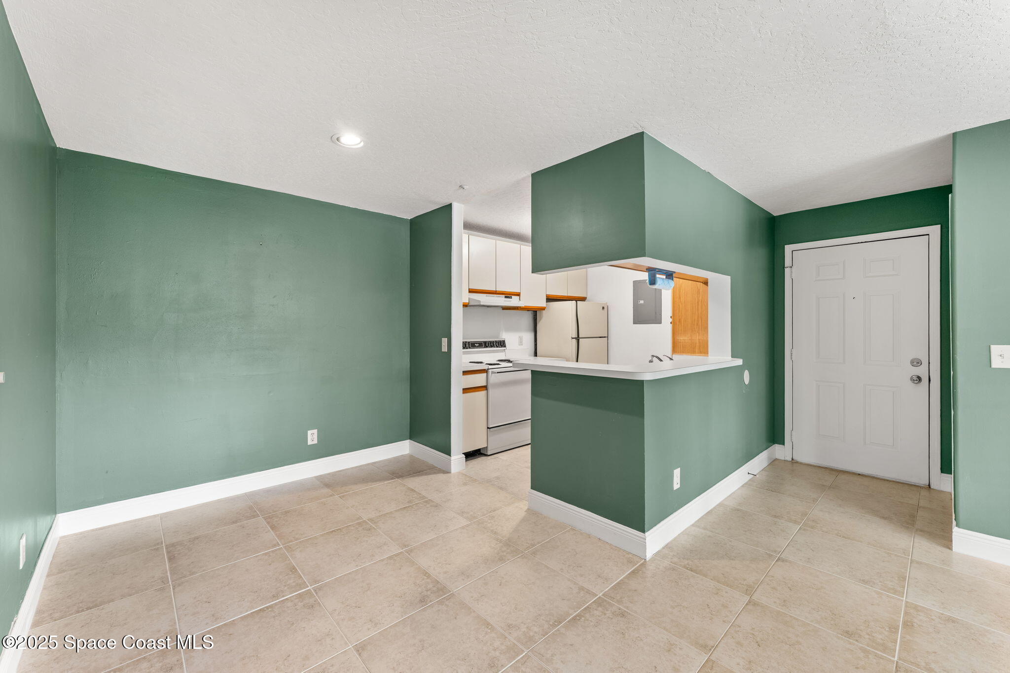 7667 North Wickham Road, Unit 712 Melbourne, FL 32940 - Photo 11 of 52 Entryway & Kitchen
