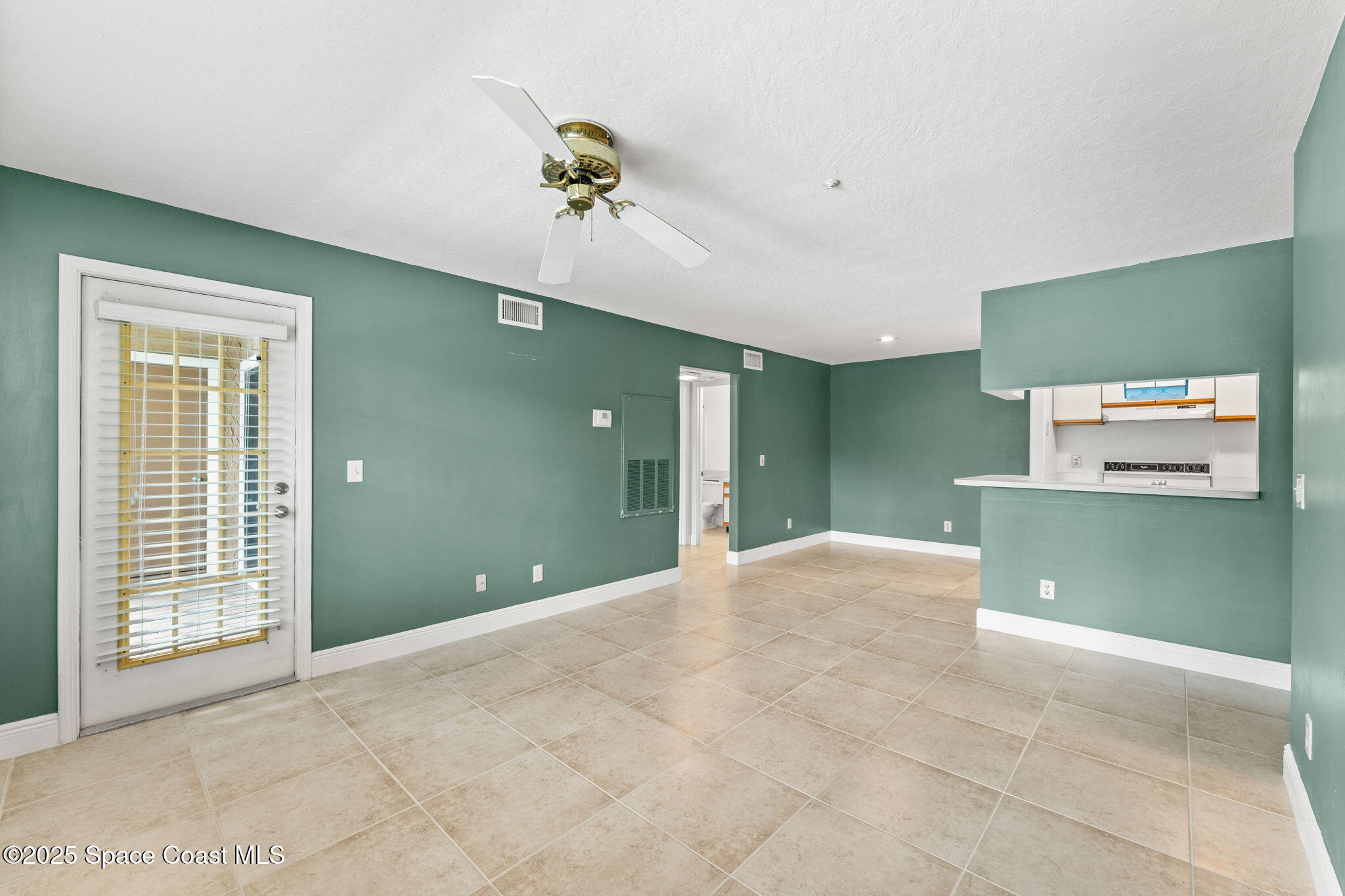7667 North Wickham Road, Unit 712 Melbourne, FL 32940 - Photo 18 of 52 Living Room & Door to Balcony