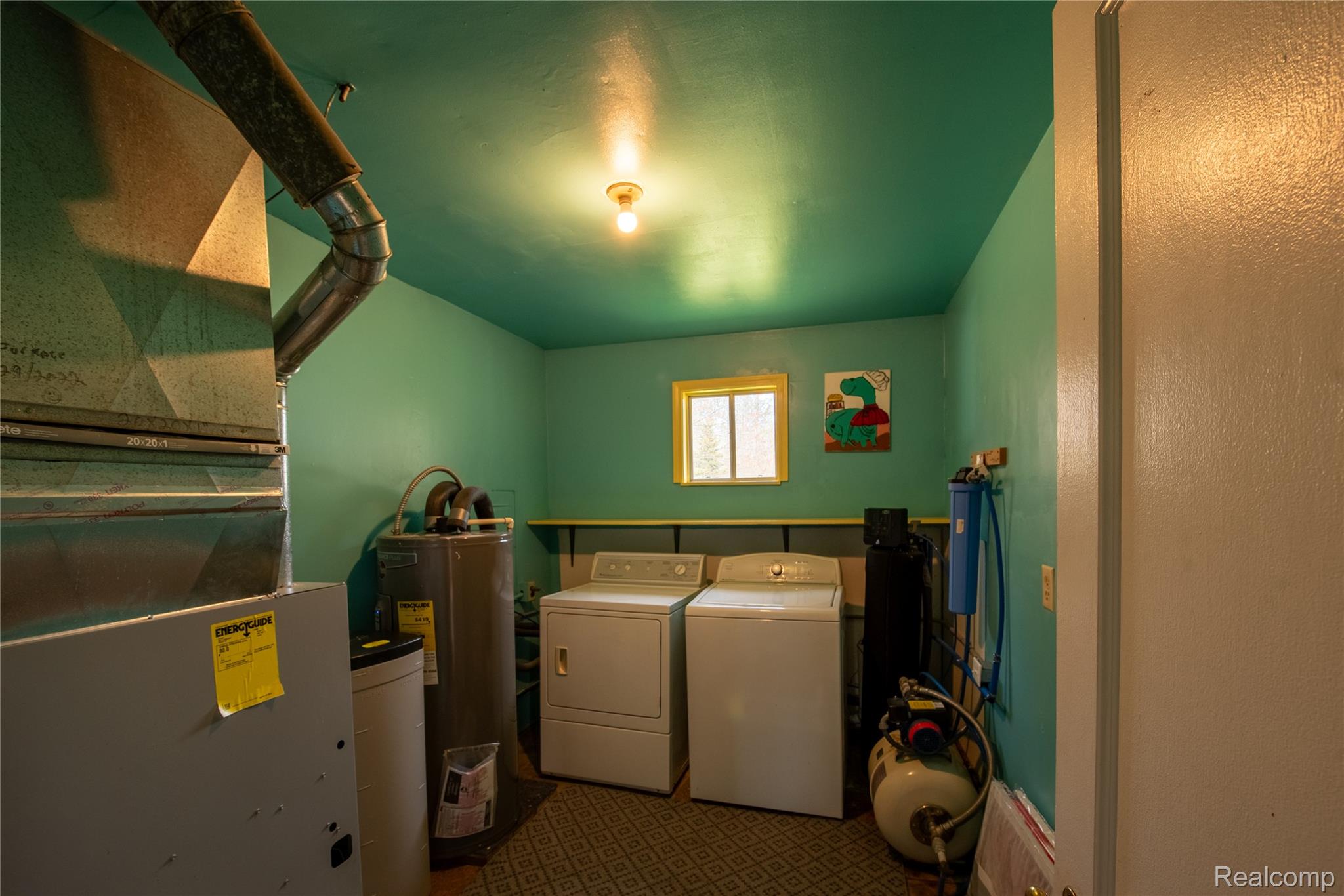 1190 Meadow Road Tawas City, MI 48763 - Photo 17 of 26 Laundry room featuring heating unit, washer and clothes dryer, and electric water heater