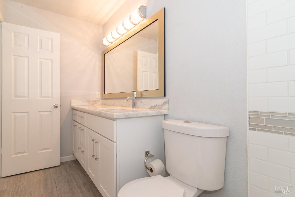 23 Baypoint Drive San Rafael, CA 94901 - Photo 29 of 40 a bathroom with a toilet sink and mirror