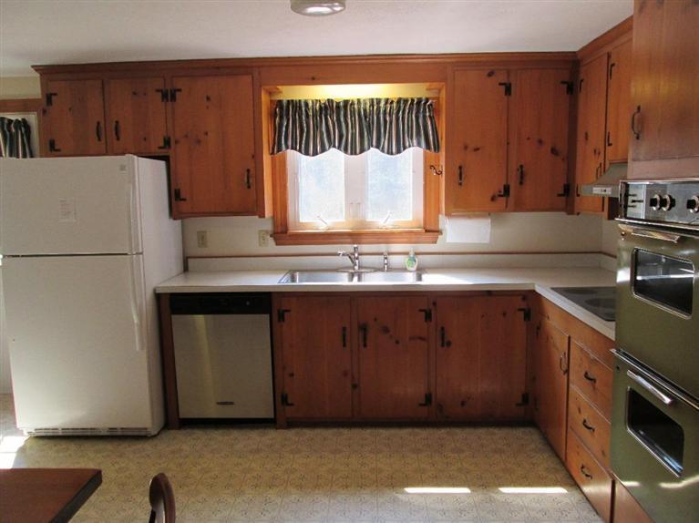 28 Eel Pond Road Monument Beach, MA 02532 - Photo 11 of 29 a kitchen with a refrigerator and a sink