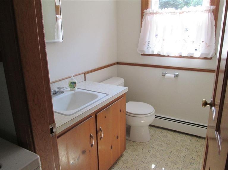 28 Eel Pond Road Monument Beach, MA 02532 - Photo 13 of 29 a bathroom with a granite countertop sink toilet and a mirror