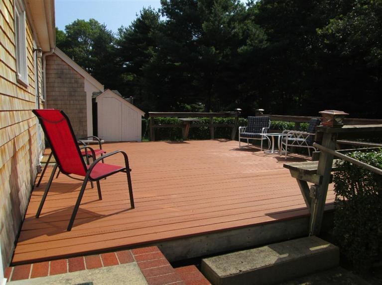 28 Eel Pond Road Monument Beach, MA 02532 - Photo 21 of 29 a view of a patio with table and chairs with wooden floor and fence