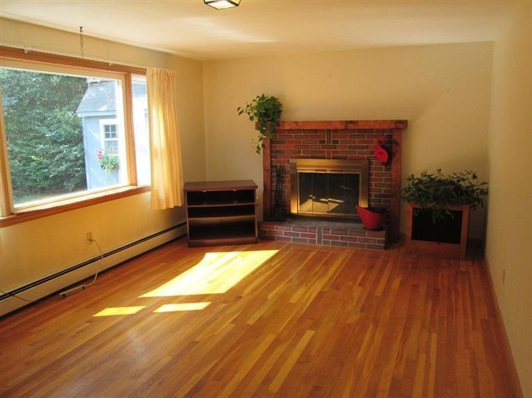 28 Eel Pond Road Monument Beach, MA 02532 - Photo 3 of 29 a room with a fireplace and a window