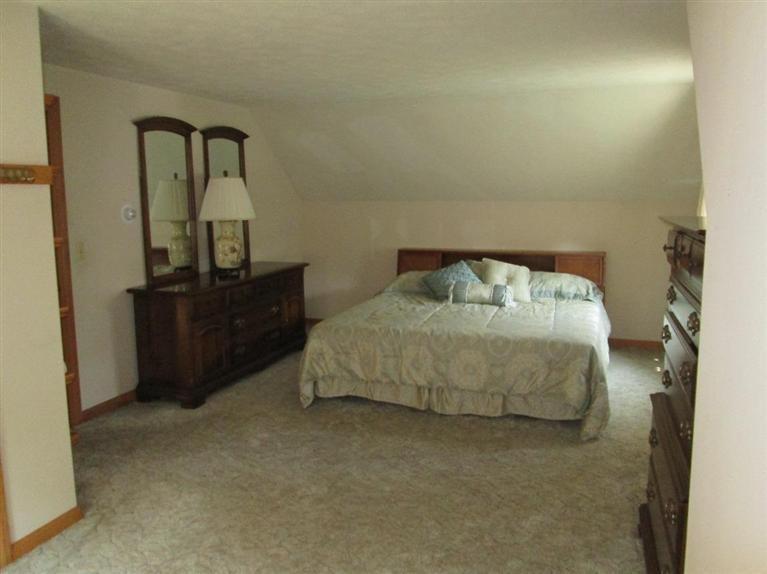 28 Eel Pond Road Monument Beach, MA 02532 - Photo 6 of 29 a bedroom with a bed and dresser