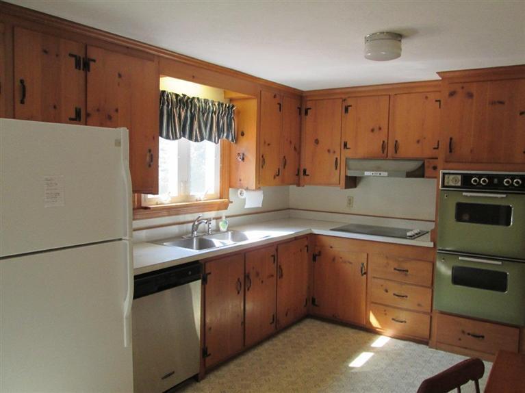 28 Eel Pond Road Monument Beach, MA 02532 - Photo 9 of 29 a kitchen with a sink stove and refrigerator