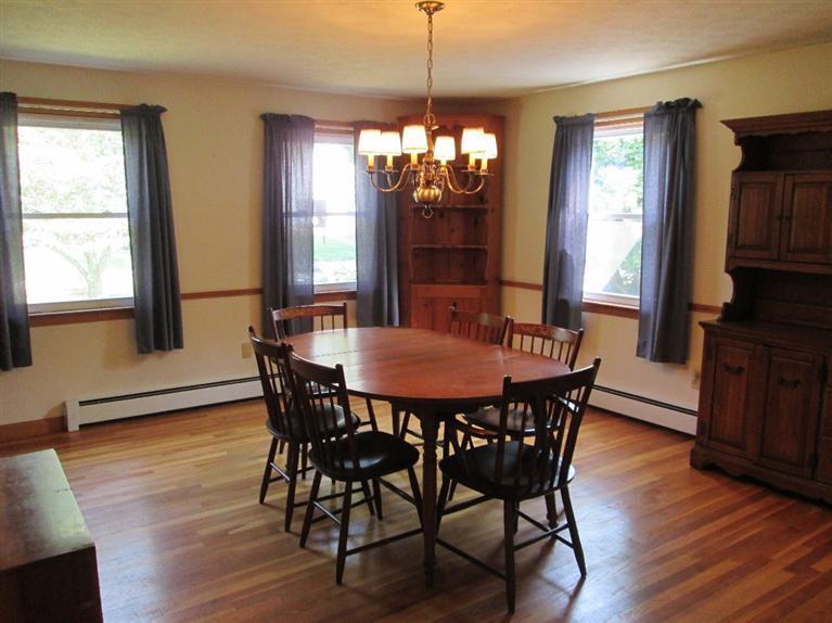 28 Eel Pond Road Monument Beach, MA 02532 - Photo 10 of 29 a view of a dining room with furniture window and wooden floor