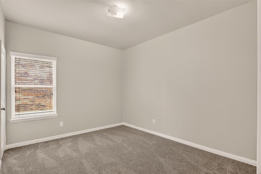 9105 Switchgrass Lane Forney, TX 75126 - Photo 5 of 20 Spacious room featuring neutral carpeting, a single window with blinds, light gray wall paint, white trim, and a flush-mount ceiling light fixture