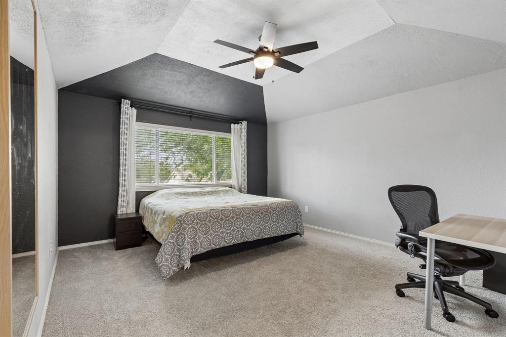 304 Lark Lane Euless, TX 76039 - Photo 17 of 32 Bedroom with light carpet, a desk, and ceiling fan