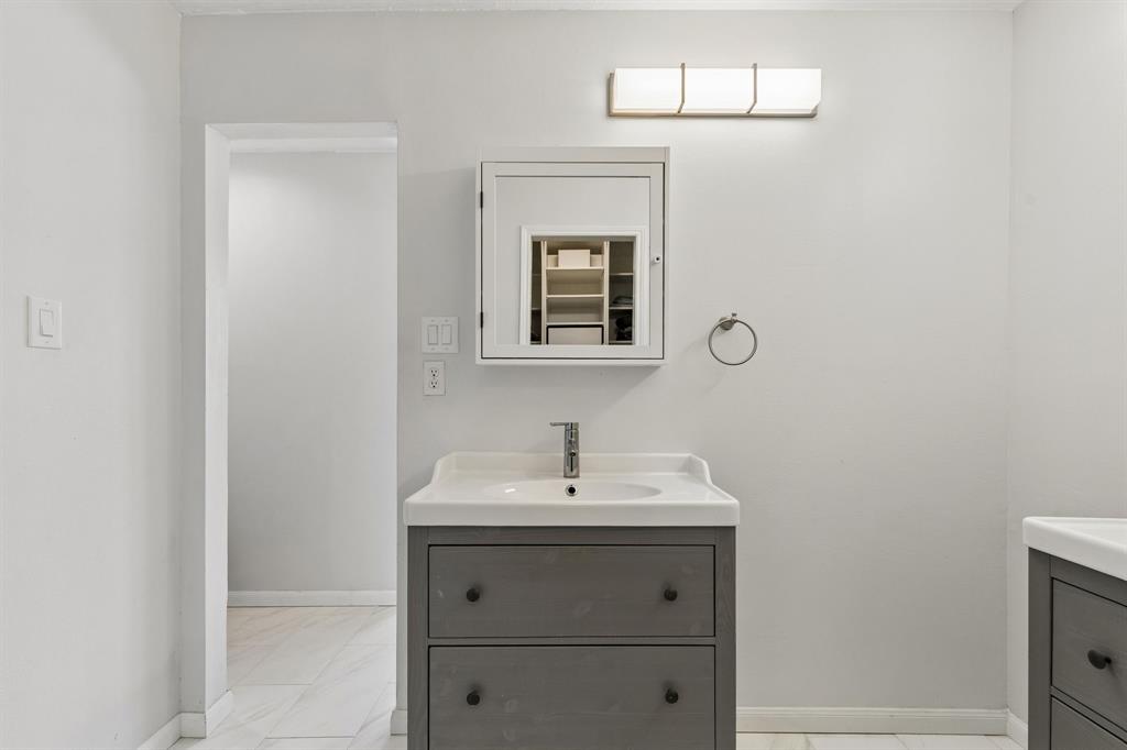 304 Lark Lane Euless, TX 76039 - Photo 19 of 32 Bathroom with vanity and light marble finish flooring