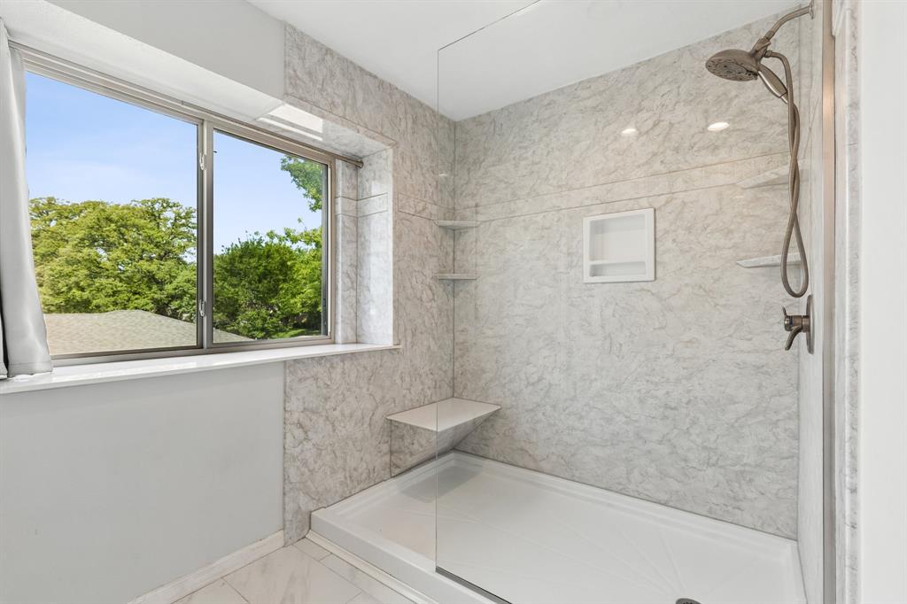 304 Lark Lane Euless, TX 76039 - Photo 20 of 32 Full bath with a marble finish shower and light marble finish flooring