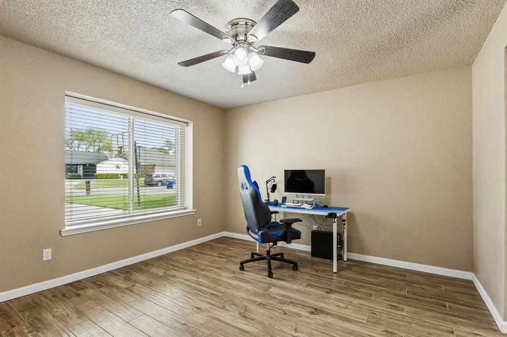 304 Lark Lane Euless, TX 76039 - Photo 25 of 32 Home office with light wood-type flooring, a textured ceiling, and ceiling fan