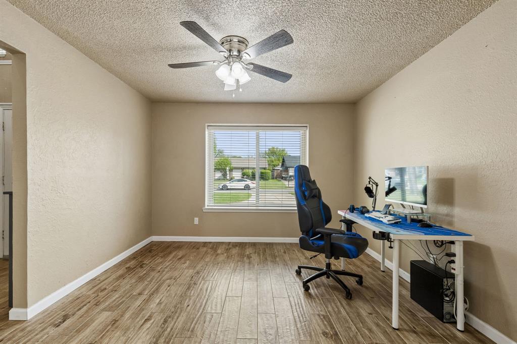 304 Lark Lane Euless, TX 76039 - Photo 26 of 32 Unfurnished office with a textured wall, a textured ceiling, ceiling fan, and light wood-type flooring