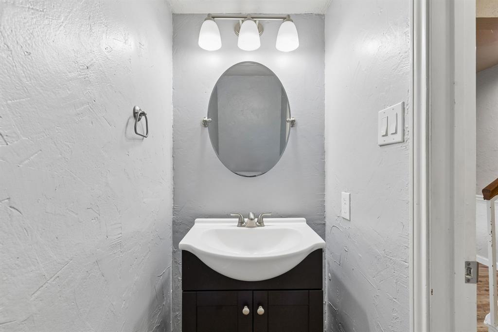 304 Lark Lane Euless, TX 76039 - Photo 29 of 32 Bathroom with vanity and a textured wall