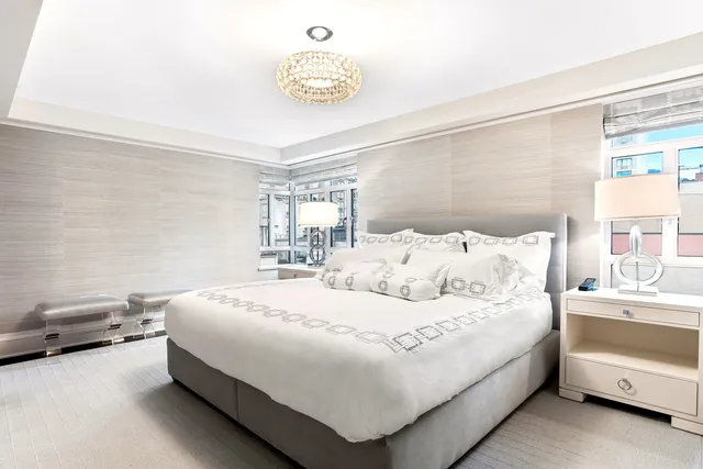 a spacious bathroom with a sink double vanity mirror and a bathtub