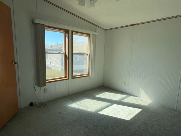 an empty room with a empty space and windows