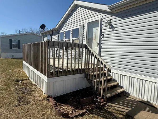 a view of a house with wooden fence