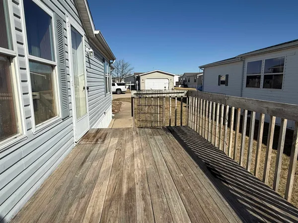 a view of a balcony with wooden floor