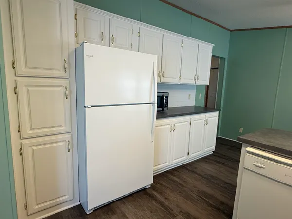 a white refrigerator freezer sitting in a kitchen