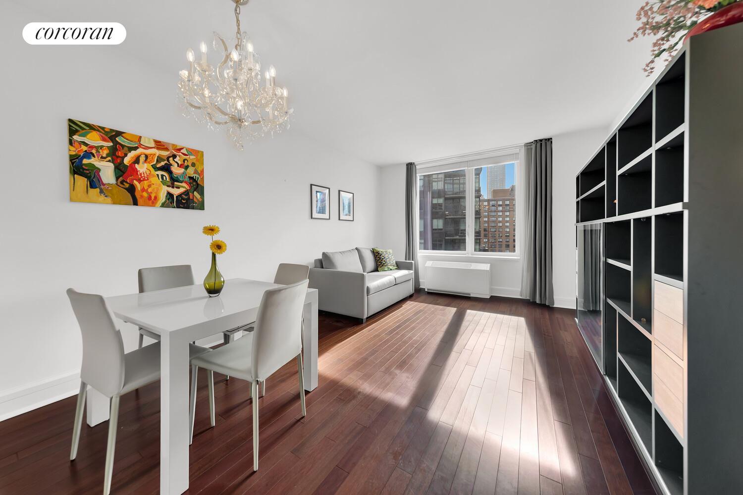 a view of a dining room with furniture wooden floor and chandelier