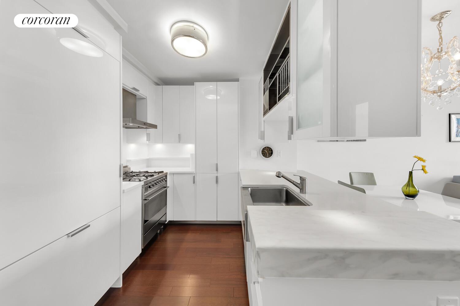 60 Riverside Boulevard, Unit 1806 Manhattan, NY 10069 - Photo 3 of 7 a kitchen with a sink and a stove top oven