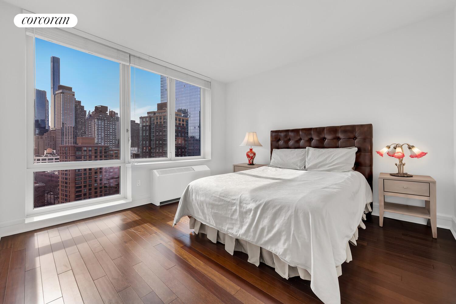 60 Riverside Boulevard, Unit 1806 Manhattan, NY 10069 - Photo 4 of 7 a bedroom with a large bed and a large window