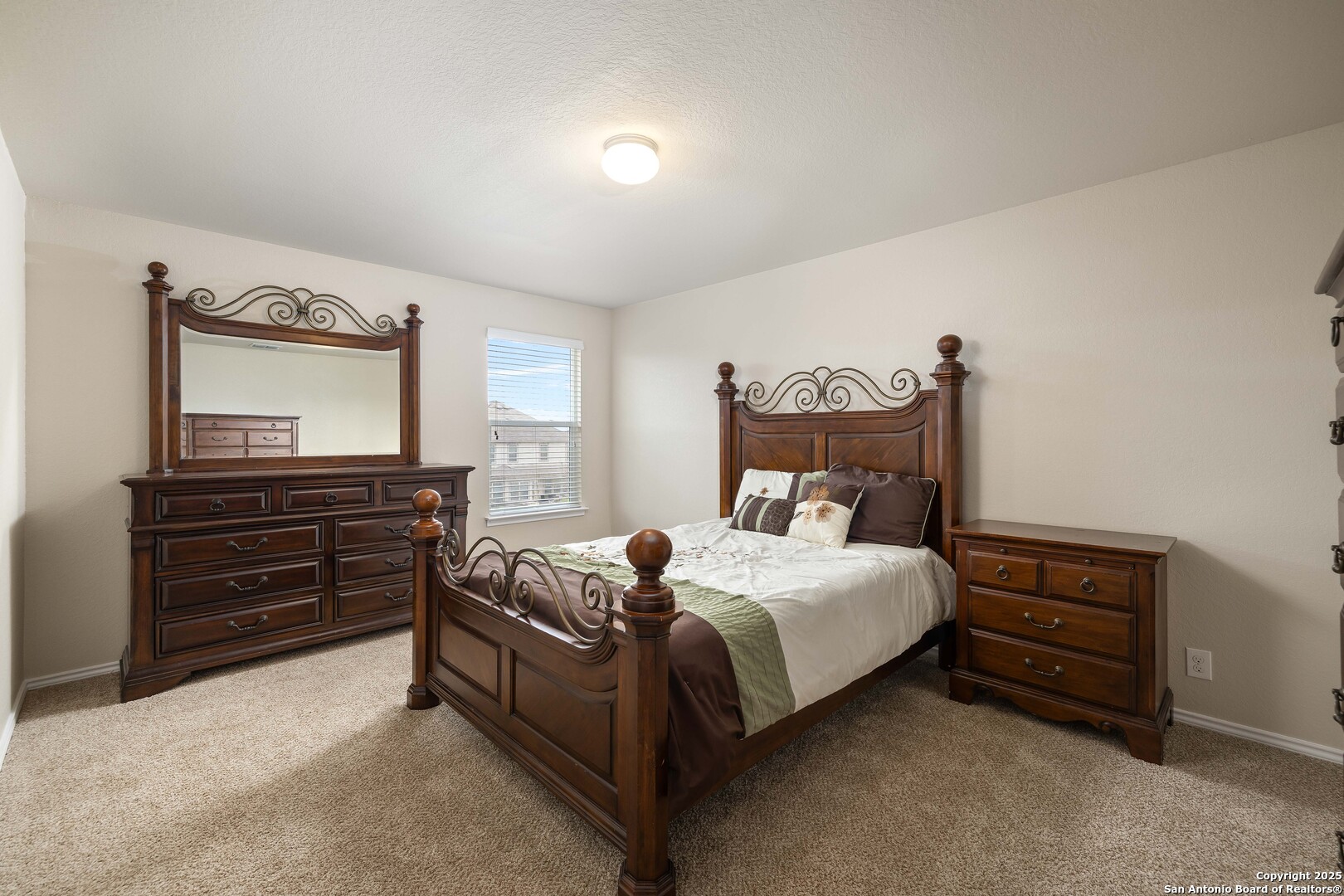 12162 Remilly Way Schertz, TX 78154 - Photo 11 of 18 a bedroom with a bed and dresser