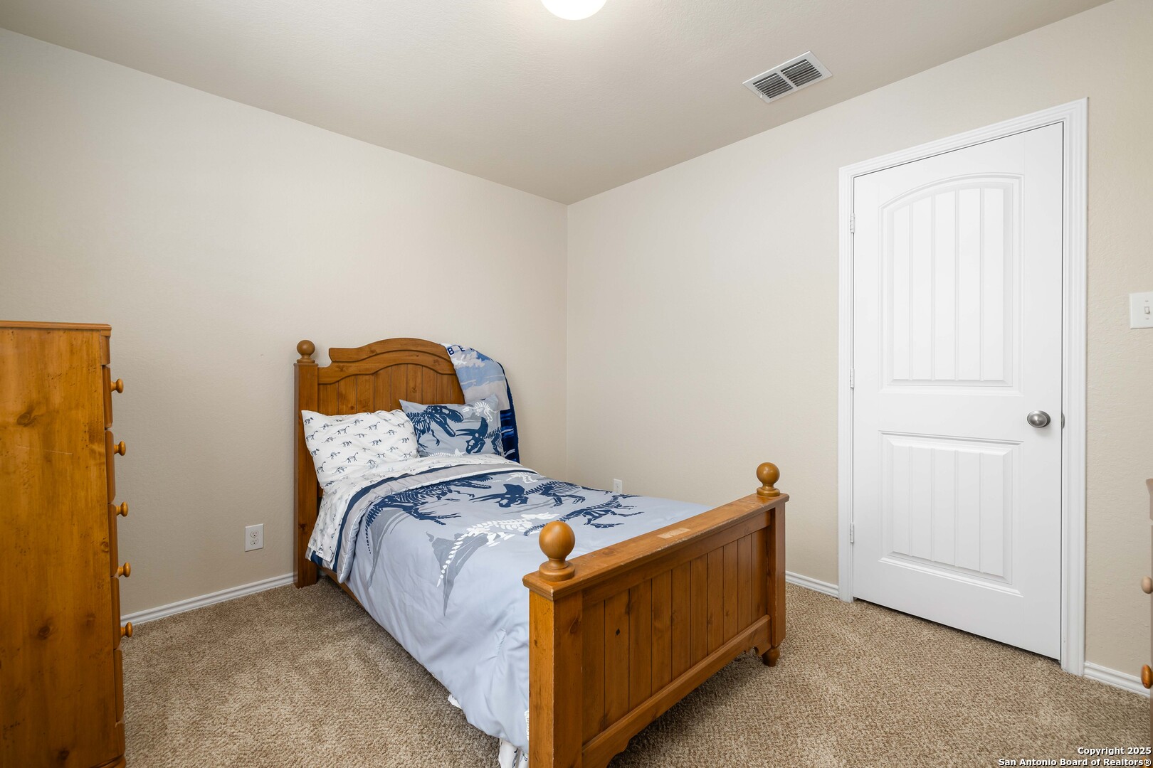12162 Remilly Way Schertz, TX 78154 - Photo 14 of 18 a bed sitting in a bedroom next to a bathroom