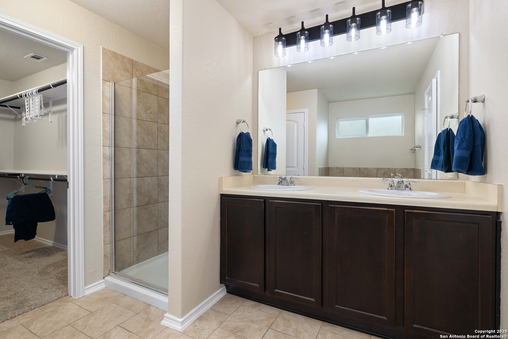 12162 Remilly Way Schertz, TX 78154 - Photo 9 of 18 a bathroom with a double vanity sink and a mirror