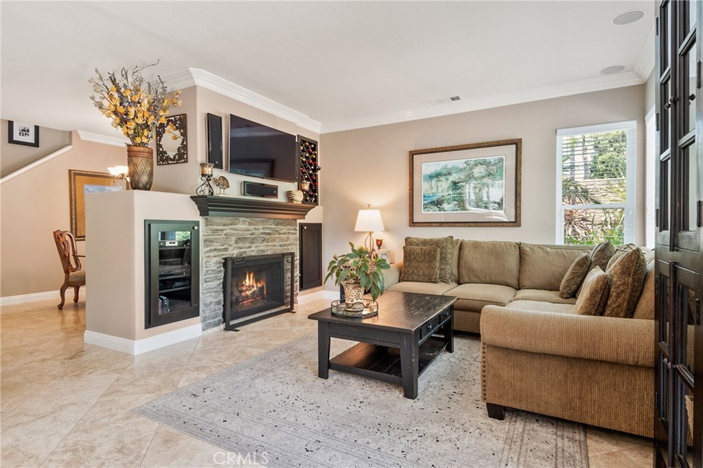 14 San Angelo Lake Forest, CA 92610 - Photo 13 of 70 a living room with furniture a flat screen tv and a fireplace