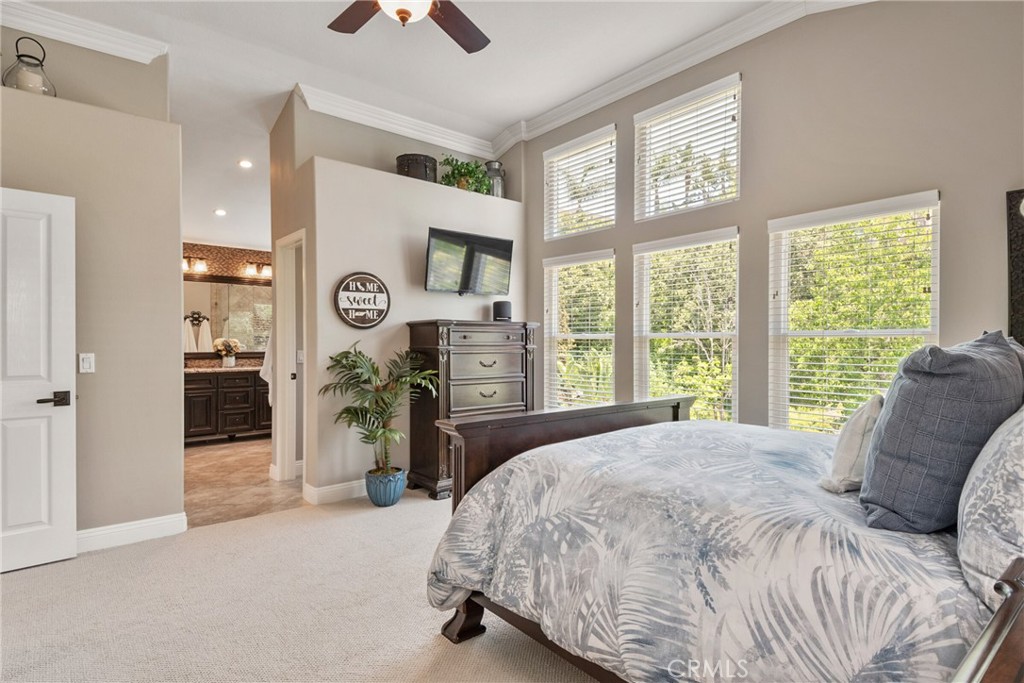 14 San Angelo Lake Forest, CA 92610 - Photo 35 of 70 a bed sitting in a spacious bedroom next to a window and a chandelier