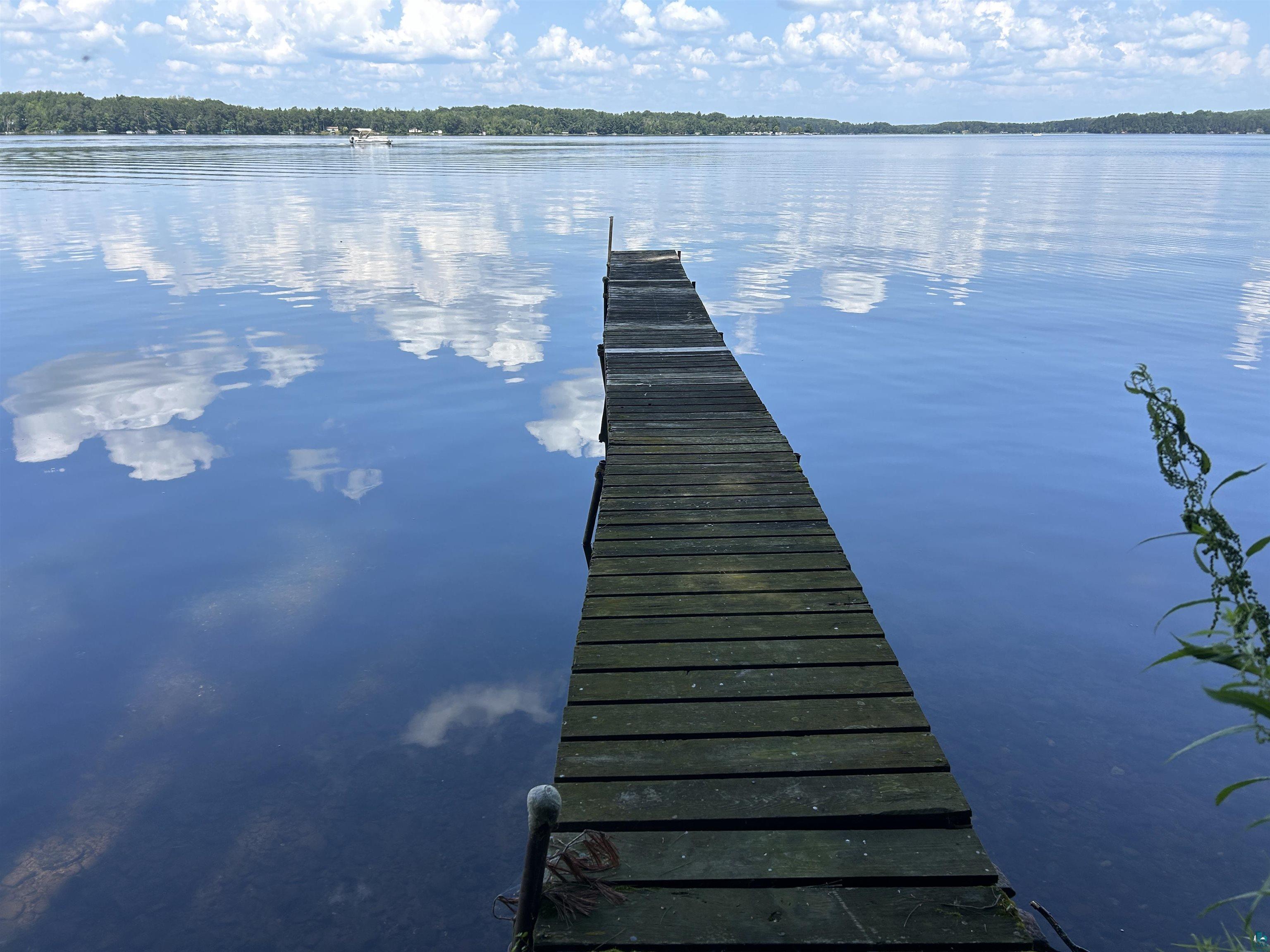 1102 Blackburn Road Spooner, WI 54801 - Photo 24 of 30 View of dock featuring a water view