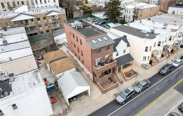 an aerial view of residential houses with outdoor space and parking