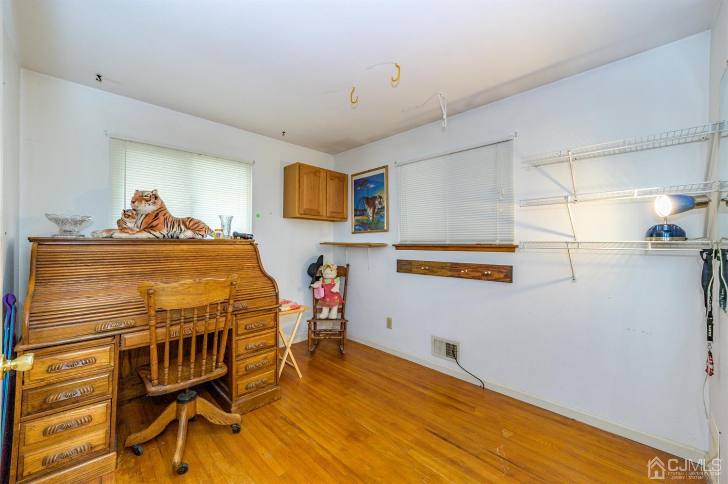 456 Dover Road Toms River, NJ 08757 - Photo 14 of 39 a bedroom with a bed and wooden floor