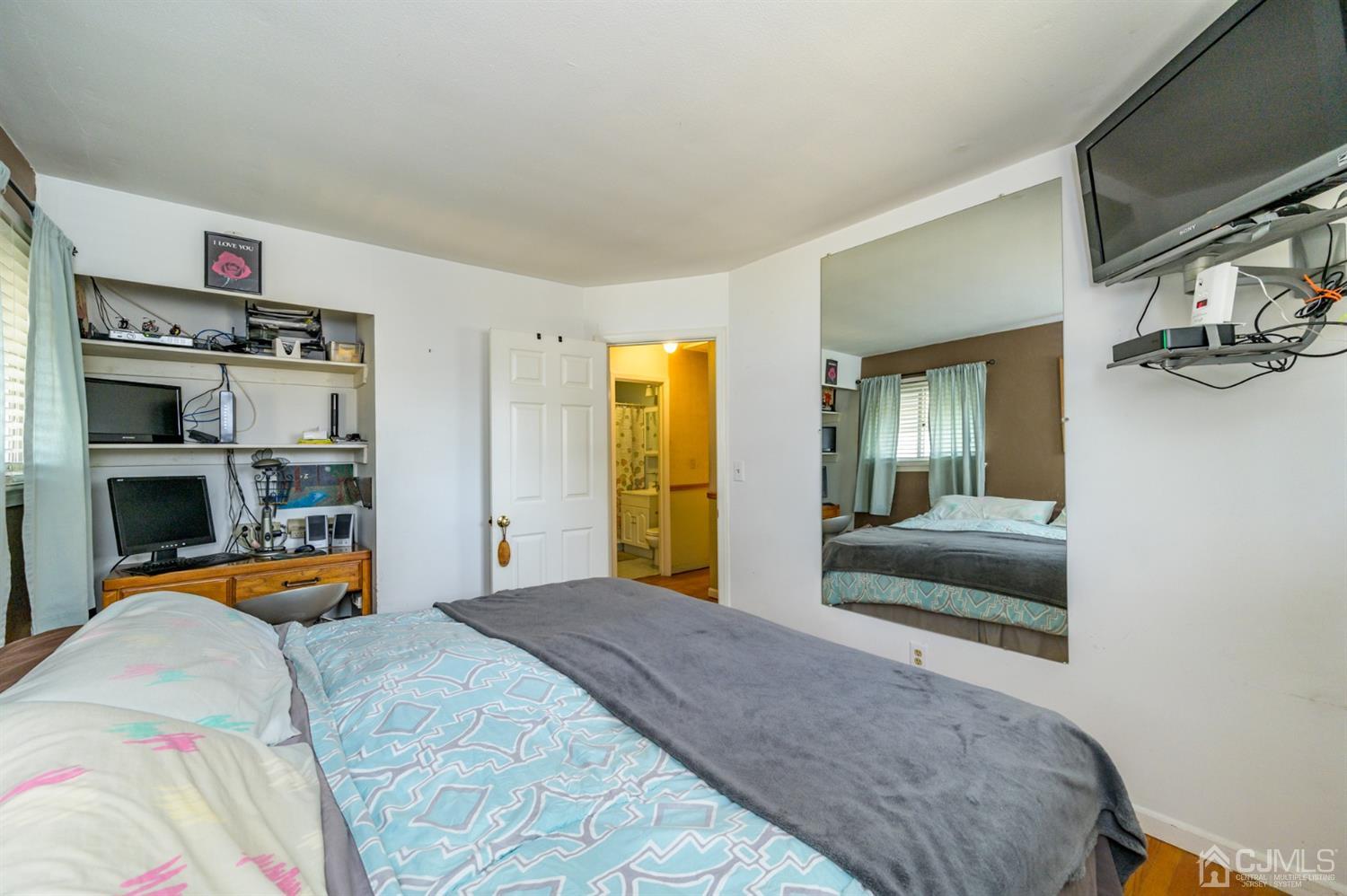 456 Dover Road Toms River, NJ 08757 - Photo 18 of 39 a bedroom with a bed and a large mirror