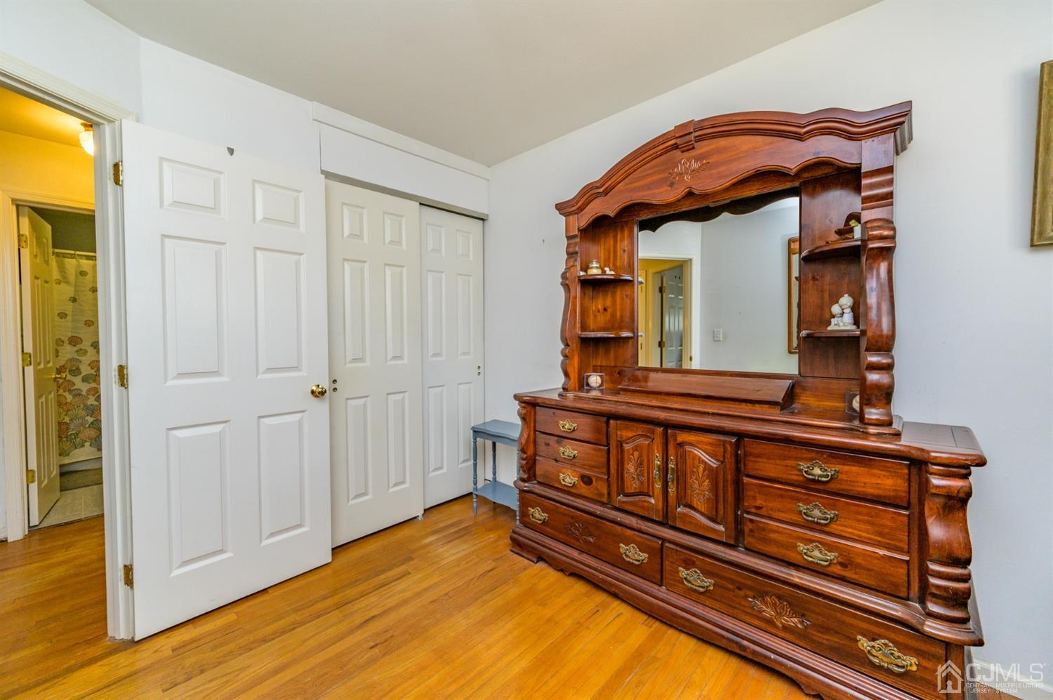 456 Dover Road Toms River, NJ 08757 - Photo 21 of 39 a bedroom with a bed and a mirror